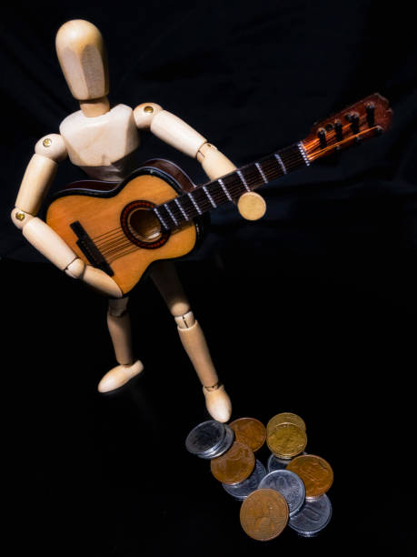 istock Wooden man figure playing guitar 839654180