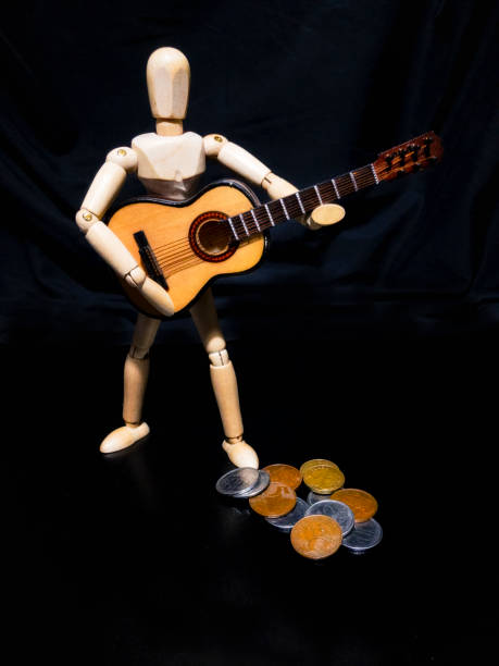 istock Wooden man figure playing guitar 839656634