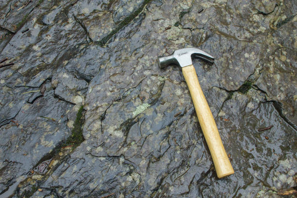 istock Metal hammer on wet stone for primitive construction. 839688512