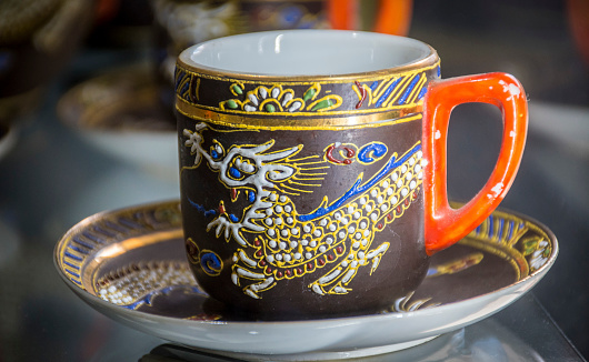 Chinese teacup with dragon raised on the side.