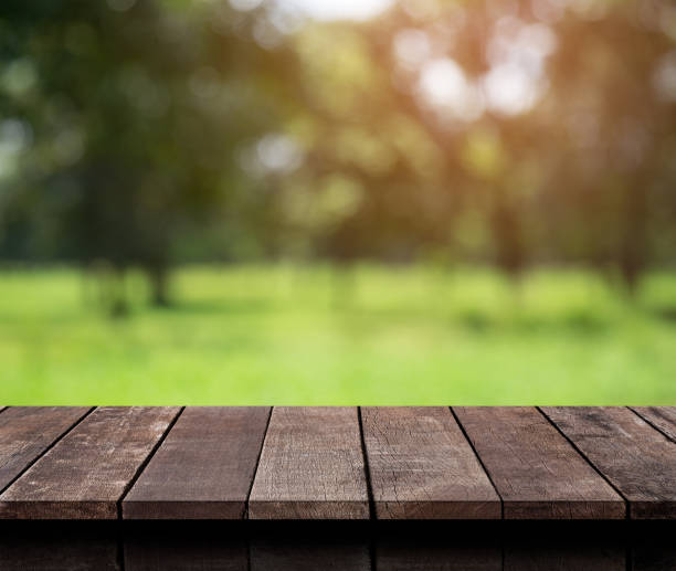 istock Empty wood table top with Green nature background.For product display 839762898