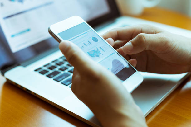 istock hands on keyboad of laptop and mobile phone 839764060