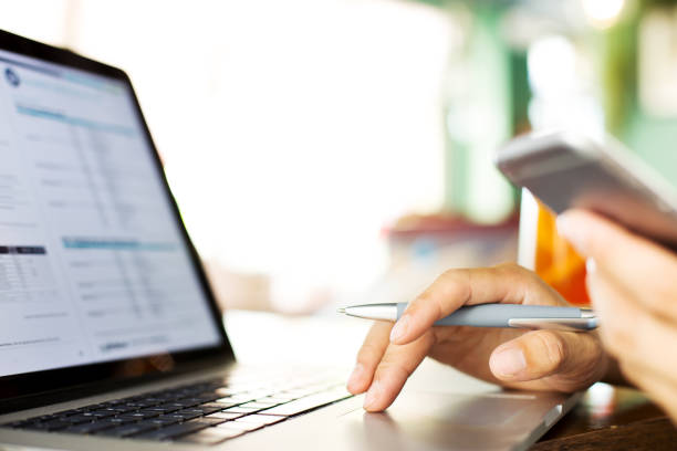 istock hand with pen on keyboard of laptop 839781954