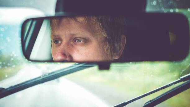 istock Thoughtful handsome man riding in car through mountains during rainy day 839788128