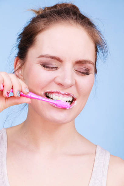 istock Woman brushing cleaning teeth 839790824