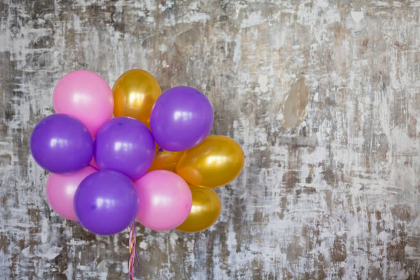 istock Bright balloons bunch against a textured wall 839794712