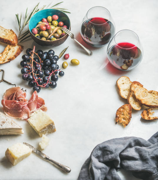 istock Cheese, olives, grapes, prosciutto, baguette and red wine, copy space 839798778
