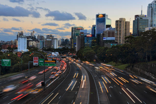 istock Traffic in motion on a busy multi lane highway with office buildings 839807226