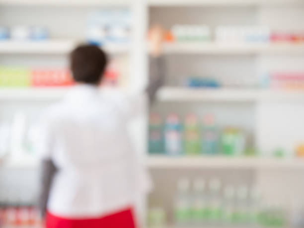 istock blur pharmacist taking medicine from shelf in pharmacy 839818296
