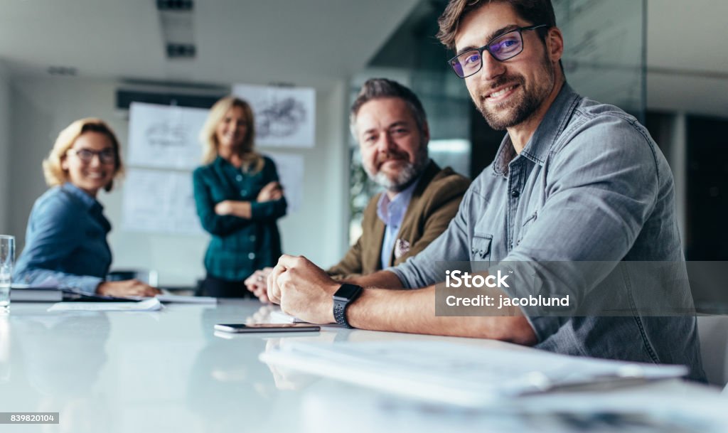 Businesspeople sitting in conference room Businesspeople sitting in conference room. Team of successful business partners in meeting hall. Business Stock Photo