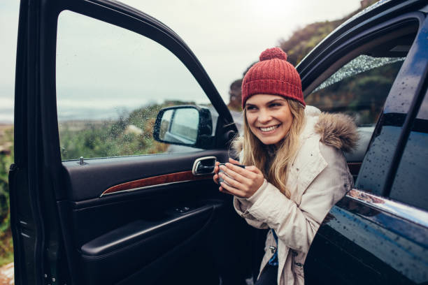 istock Beautiful smiling woman in her car drinking coffee 839822482