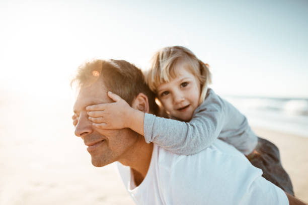 istock dad take daughter on piggyback 839822736