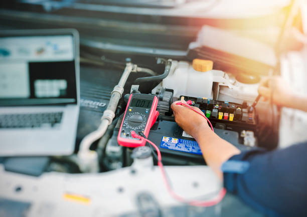 Auto mechanic using digital multimeter. Auto mechanic using digital multimeter to check the fuse in a car,check voltage level car battery. multimeter stock pictures, royalty-free photos & images