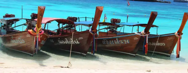 Traditional longtail boats in Thailand Koh Lipe with turquoise background sea