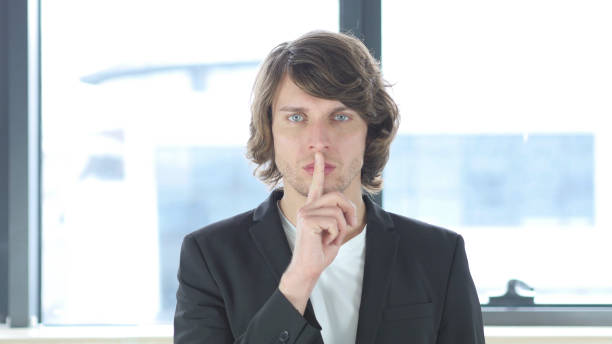 istock Gesture of Silence, Finger on Lips In His Office 839829440