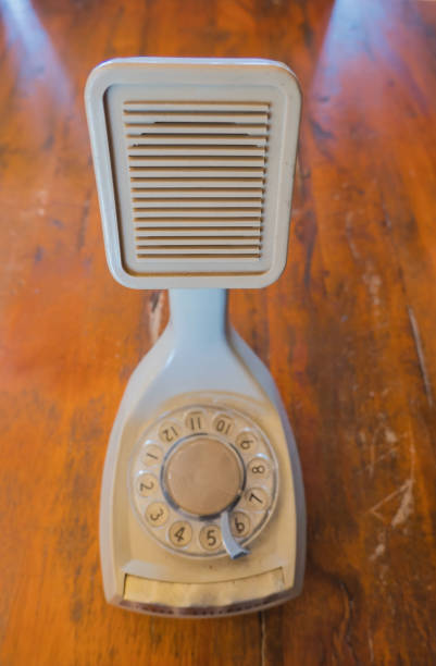 istock Closeup Vintage White phone on a wooden table background 839834176