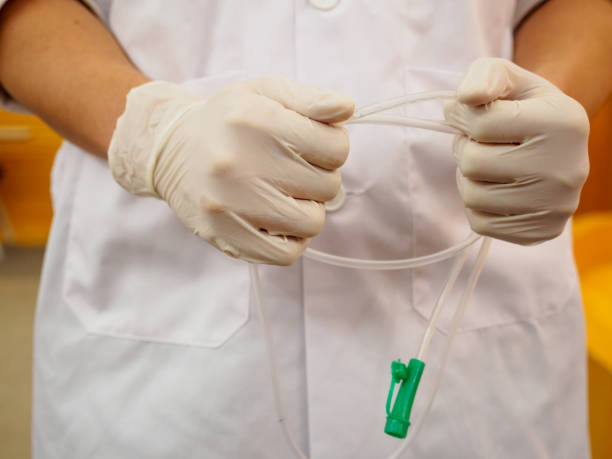 Physician wearing gloves hold nasogastric tube stock photo