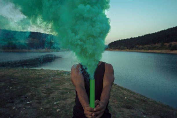 istock Man Holding Green Smoke 839842426