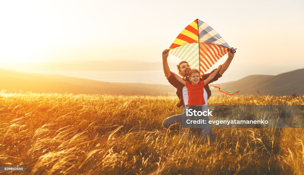 happy family father and baby daughter launch  kite on meadow happy family father and baby daughter launch a kite on meadow Child Stock Photo