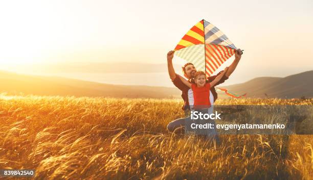 Happy Family Father And Baby Daughter Launch Kite On Meadow Stock Photo - Download Image Now