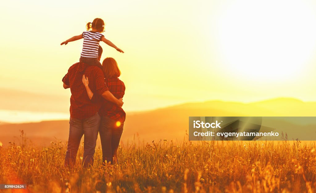 Familia feliz: madre hija padre e hijo en puesta de sol - Foto de stock de Familia libre de derechos