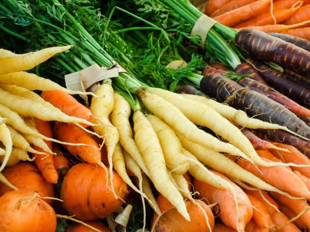 istock Bulk organic multi colored carrots at a farmer's market in Seattle 839844920