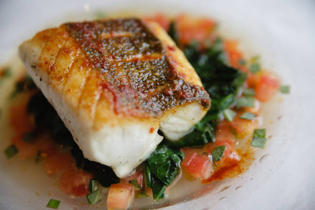 Seared sous vide cod filet on a bed of vegetables