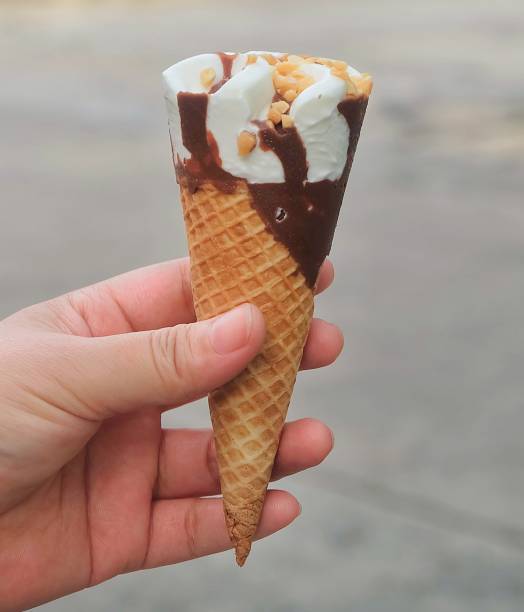 istock Hand Holding Ice Cream Cones with Chocolate 839852902