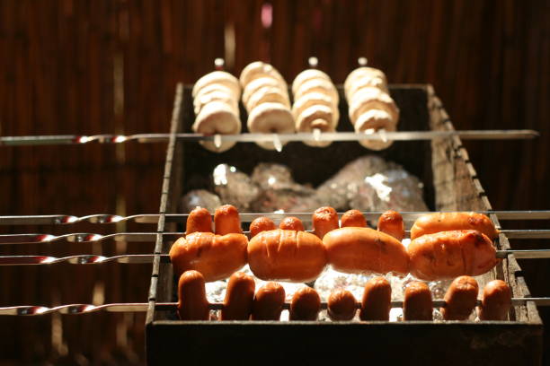 Delicious sausages and mushrooms barbecue on grill