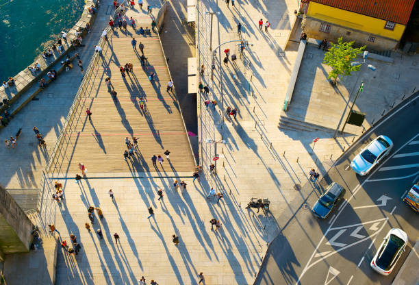 Aerial view of a people walking on the street at sunset
