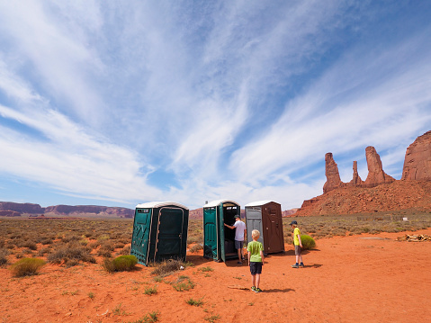 Monument Valley, USA - 25 July 2016: Tourists are inspecting portable portapotty toilets at a car park at Monument Valley Navajo Tribal Park.