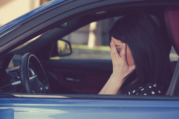 stressed young woman driver sitting inside her car - speeding ticket imagens e fotografias de stock