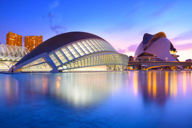 The city of the Arts and Sciences at the blue hour, Valencia, Spain Valencia, Spain - July 31, 2016: The city of the Arts and Sciences and his reflection in the water at dusk. This complex of modern buildings was designed by the architect Santiago Calatrava blue hour twilight stock pictures, royalty-free photos & images