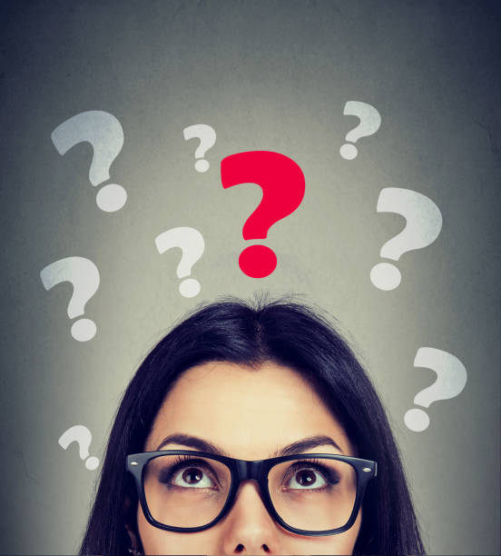 istock Serious young woman looking up at key question 839872130