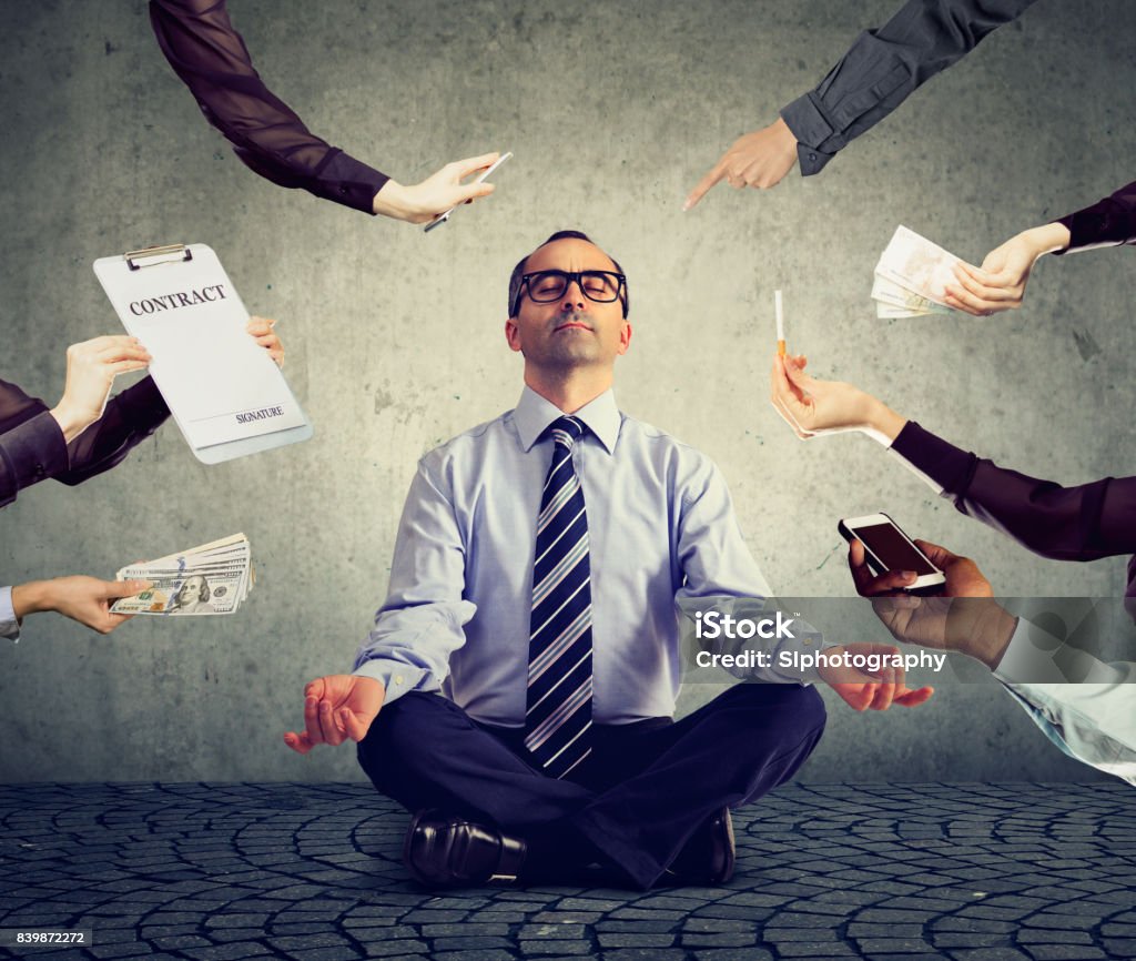 Mature business man is meditating to relieve stress of busy corporate life Working Stock Photo