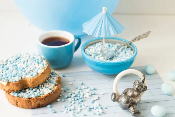 traditional dutch biscuits with blue muisjes and silver toy rattle
