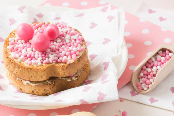 istock dutch white and pink sprinkles in a wooden spoon, with crispy biscuit, 839875612