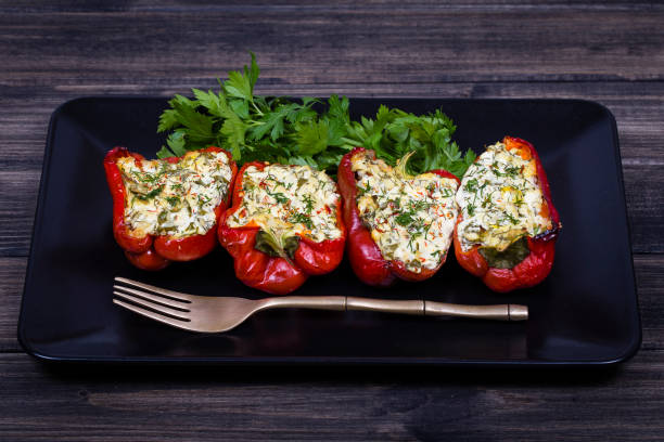 istock Stuffed red peppers in black plate 839876574