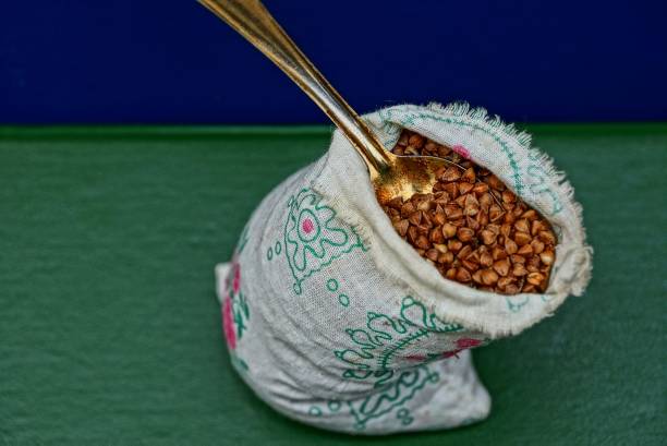 istock brown buckwheat in a bag with a spoon 839878876