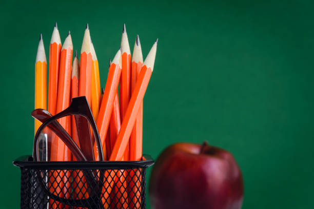 istock Pencil and apple on a white wooden table 839879184