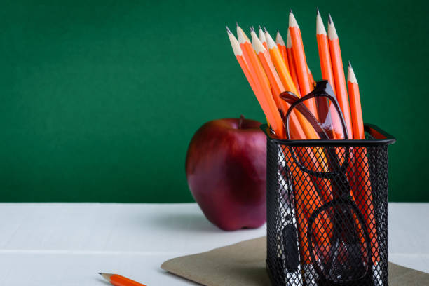 istock Books Pencil and apple on a white wooden table 839879194