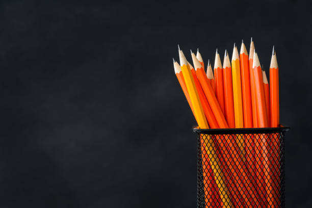 istock book and pencil on white table black board background 839879202