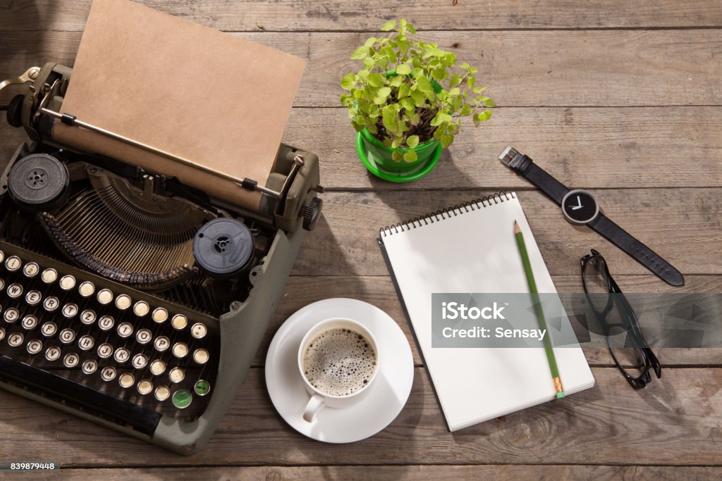 Vintage typewriter on the old wooden desk Author Stock Photo