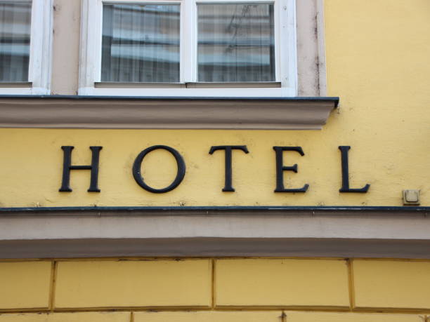 istock Black Hotel Text Sign on Yellow Building 839879668