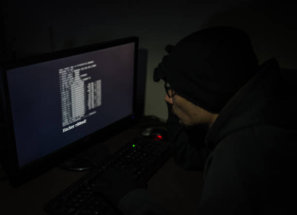 istock Hacker attack the server in the dark.Male hacker technology.Anonymous hacker with laptop in the dark. Cyber security concept. 839880592