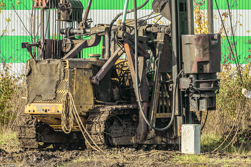 Crawler mobile diesel pile hammer working on construction site. Working process of driving reinforced concrete pile with a heavy diesel hammer.