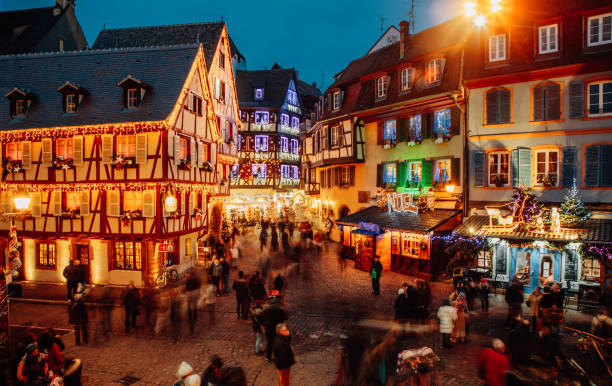 Christmas time in Colmar, Alsace, France Old town illuminated and decorate magical like a fairy tale in Noel festive season. People togetherness and happiness enjoying Christmas markets in Colmar, Alsace, France. colmar stock pictures, royalty-free photos & images