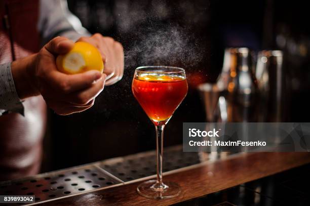 Bartender Is Adding Lemon Zest To The Cocktail At Bar Counter Stock Photo - Download Image Now