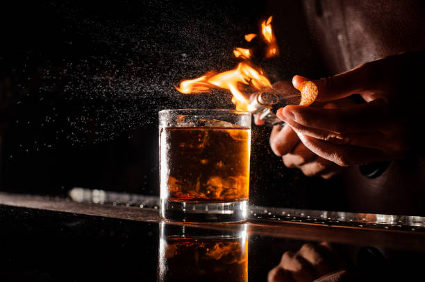 istock The bartender makes flame above cocktail close up 839893286