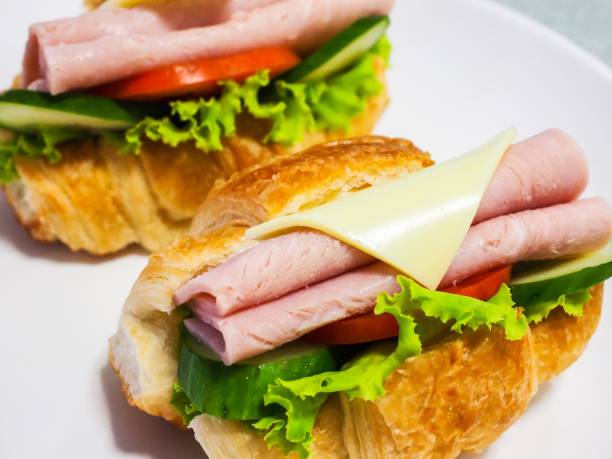 istock Croissant with ham cheese and lettuce 839893440